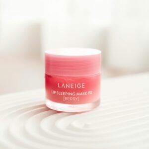 Close-up of Laneige Lip Sleeping Mask EX in berry flavor on textured surface. Product photography.